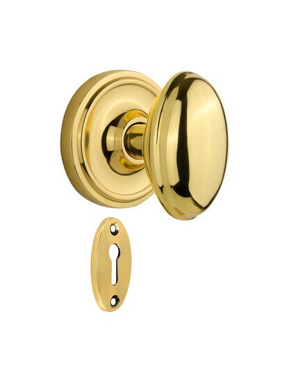 Classic Rosette Mortise-Lock Set with Homestead Knobs in Polished Brass.
